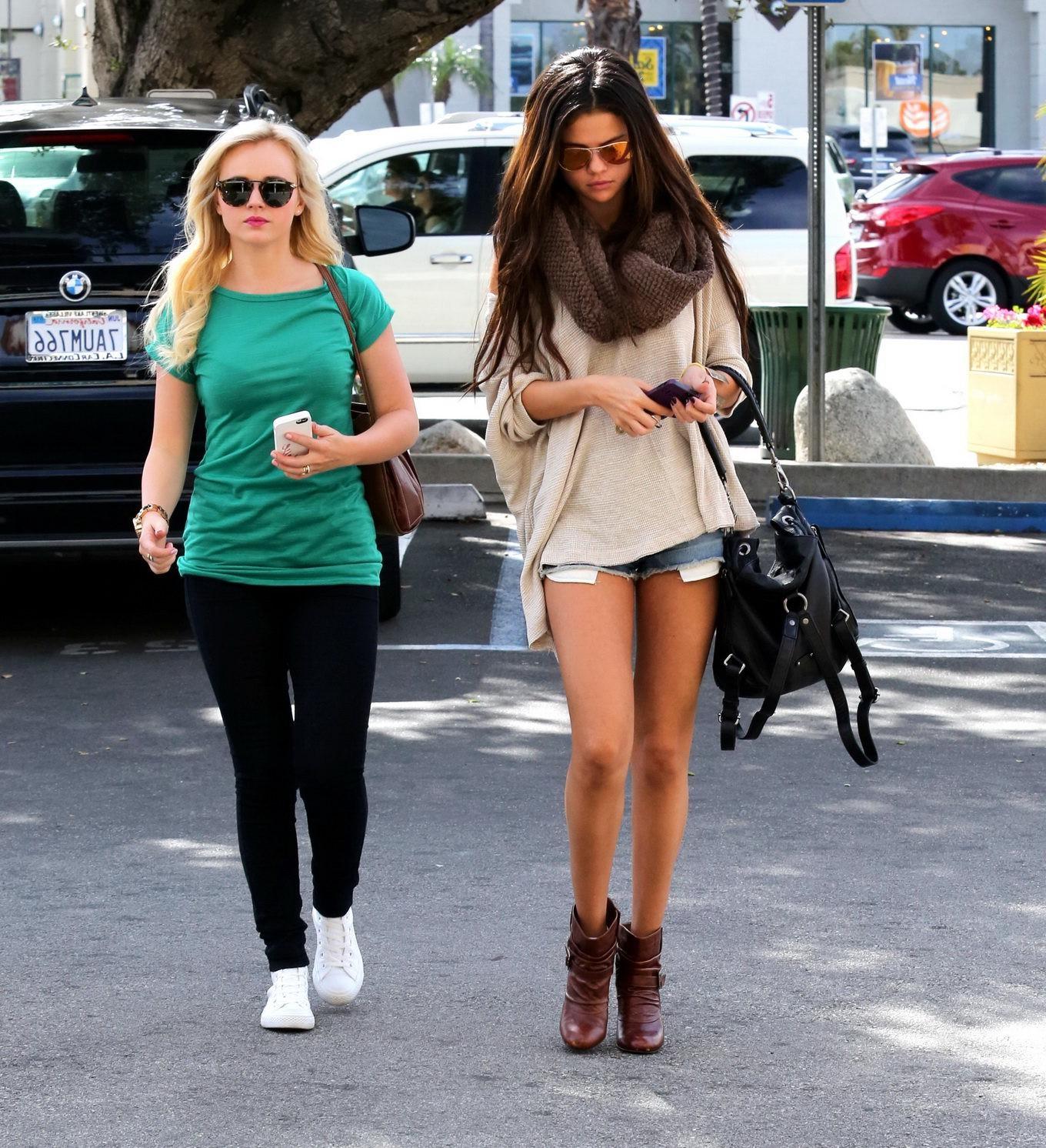 16P Selena Gomez leggy wearing a denim shorts  ankle boots at 'Little Cafe' in LA