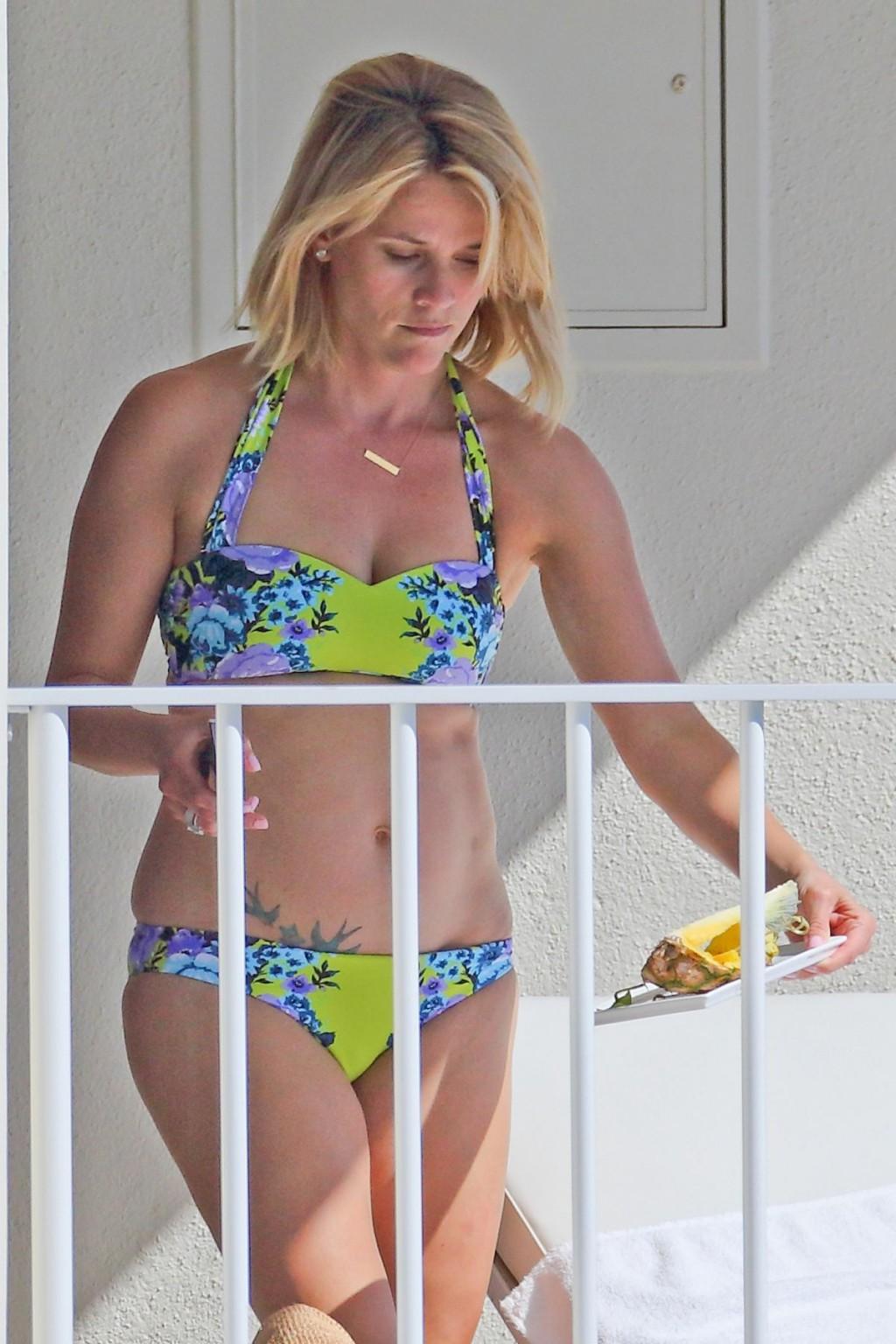 16P Reese Witherspoon wearing a nature colored bikini on a hotel balcony in Hawaii
