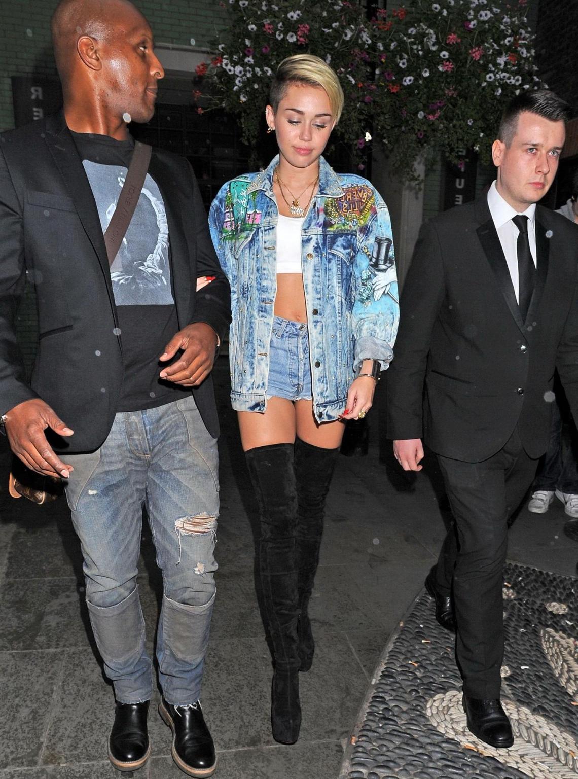 16P Miley Cyrus wearing denim hotpants  fuck-me boots out in London
