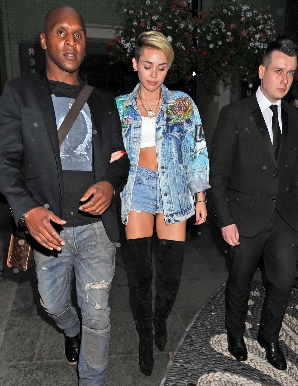 16P Miley Cyrus wearing denim hotpants  fuck-me boots out in London