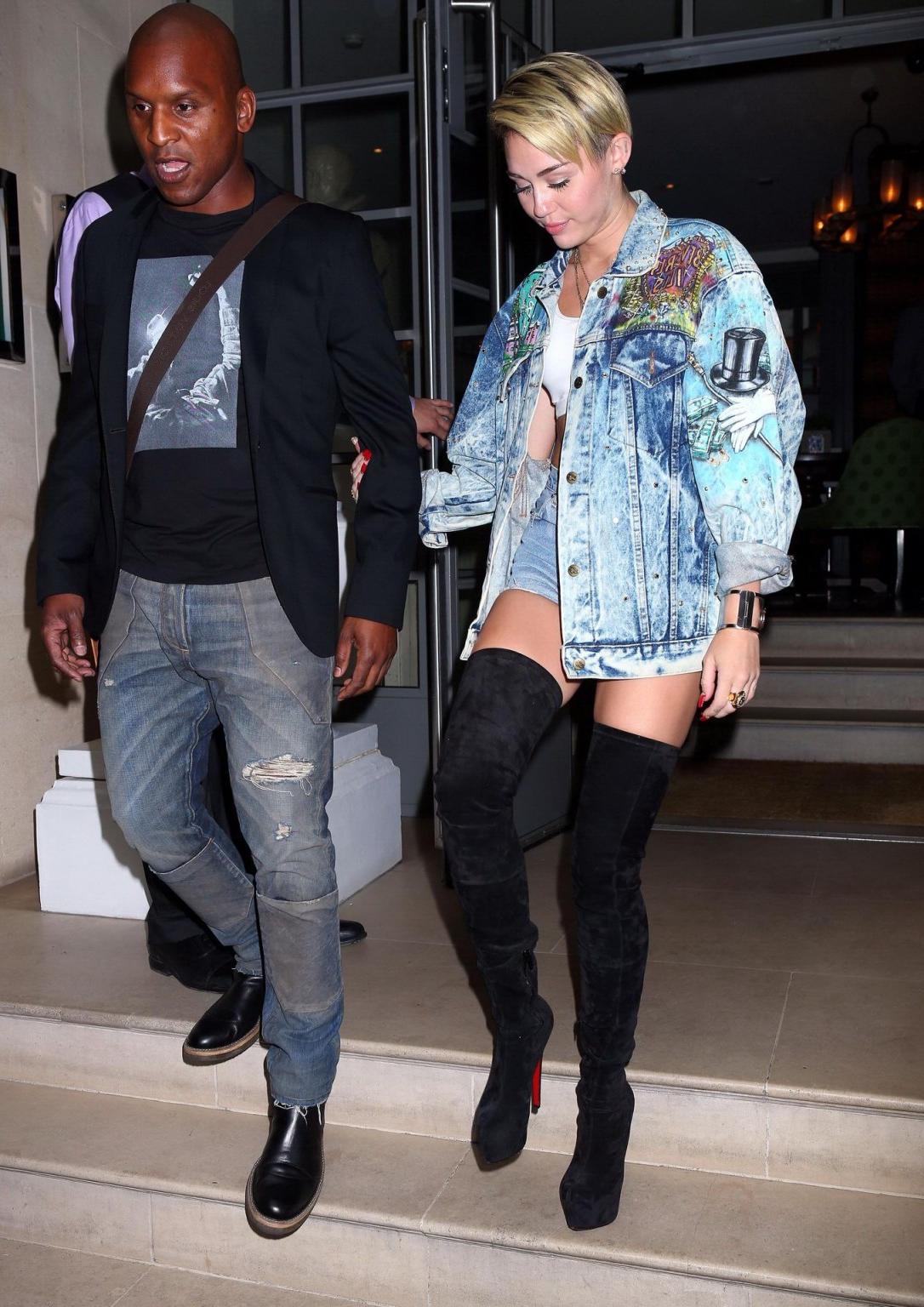 16P Miley Cyrus wearing denim hotpants  fuck-me boots out in London