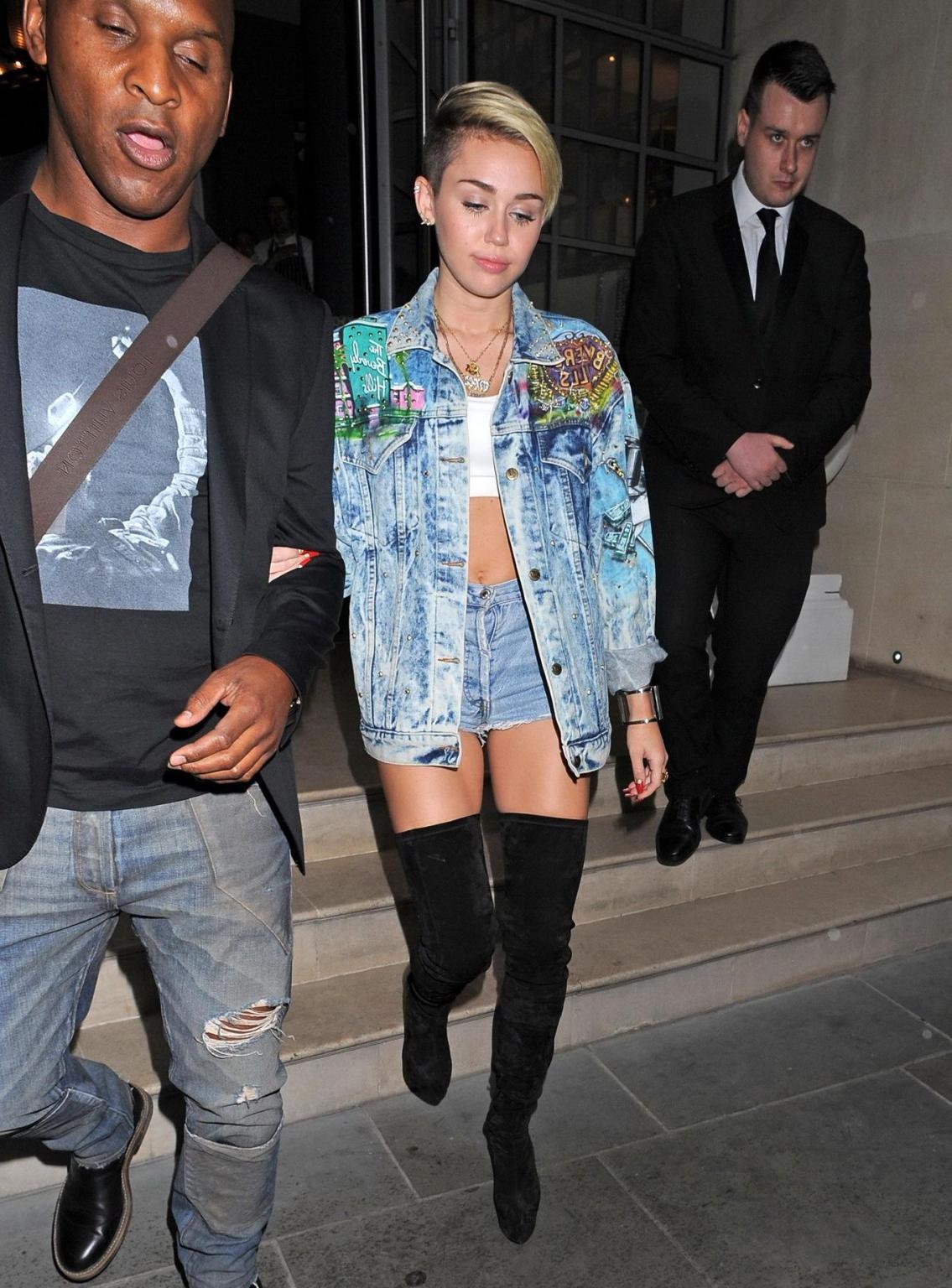 16P Miley Cyrus wearing denim hotpants  fuck-me boots out in London