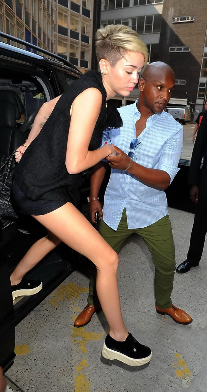 16P Miley Cyrus flashing her booty in tiny shorts while out for shopping in London