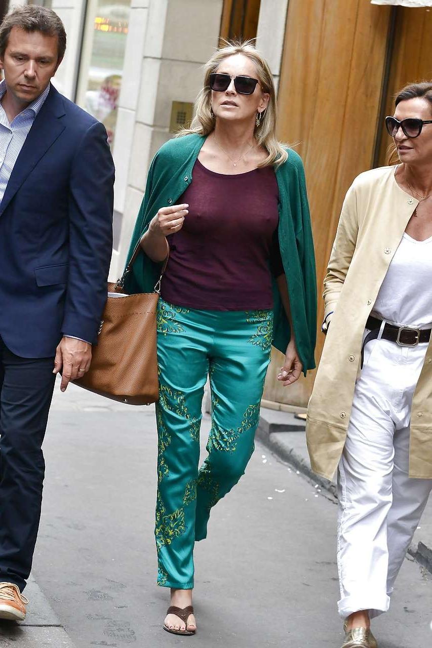 16P Sharon Stone exposing great boobs in see thru shirt on street