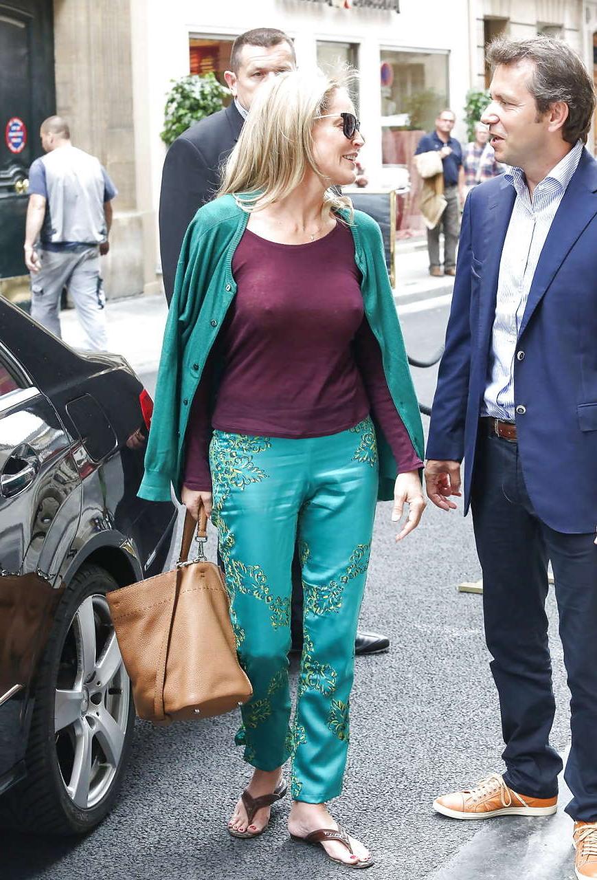 16P Sharon Stone exposing great boobs in see thru shirt on street