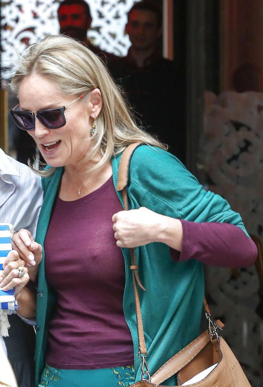 16P Sharon Stone exposing great boobs in see thru shirt on street