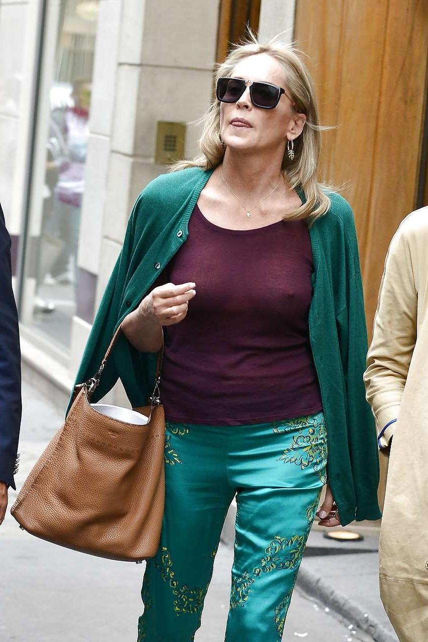 16P Sharon Stone exposing great boobs in see thru shirt on street
