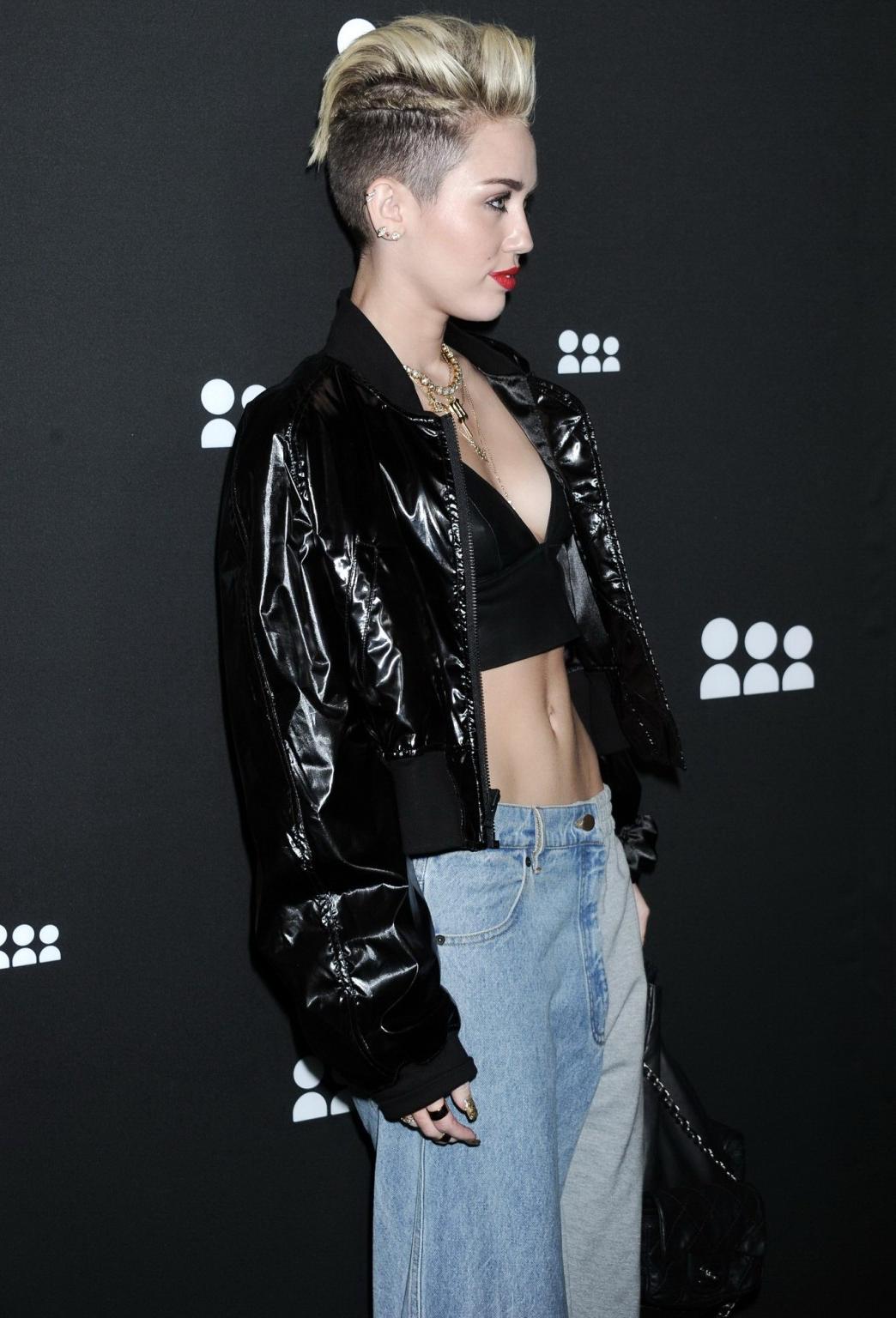 16P Miley Cyrus wearing a leather crop top at the Myspace launch event