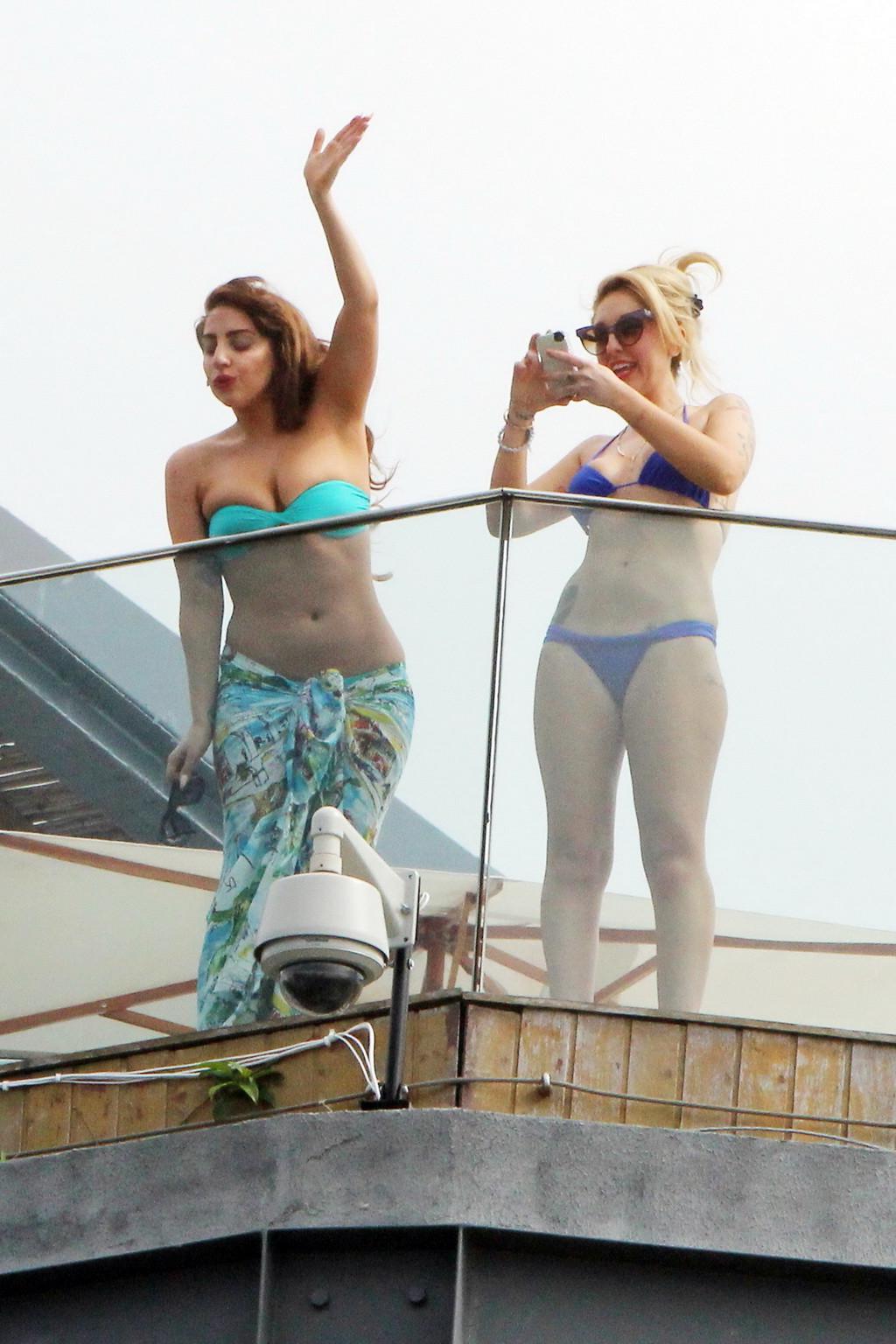 10P Lady Gaga topless on a hotel balcony in Rio trying to hide her boobs