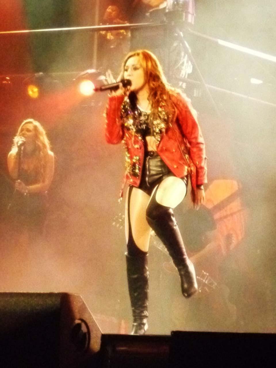 16P Miley Cyrus showing huge cleavage and lot of legs in shorts and high boots on st