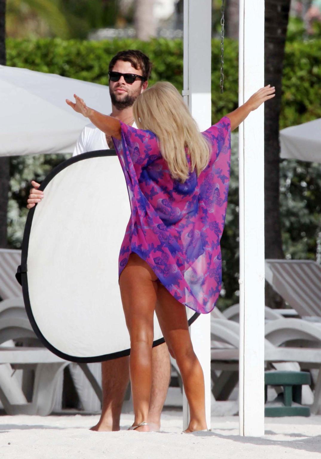 16P Geri Halliwell busty wearing navy strip bikini out on her hotel balcony in Miami
