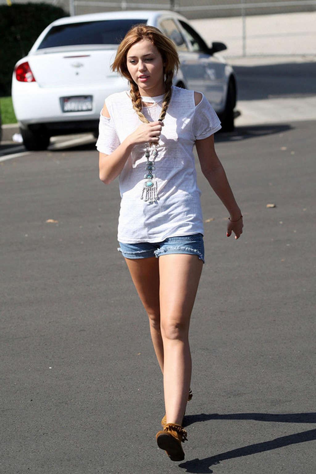 16P Miley Cyrus exposing sexy legs in shorts and hard nipples on street