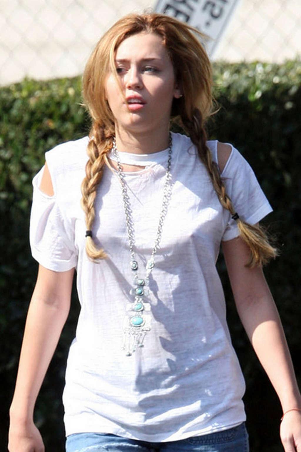 16P Miley Cyrus exposing sexy legs in shorts and hard nipples on street