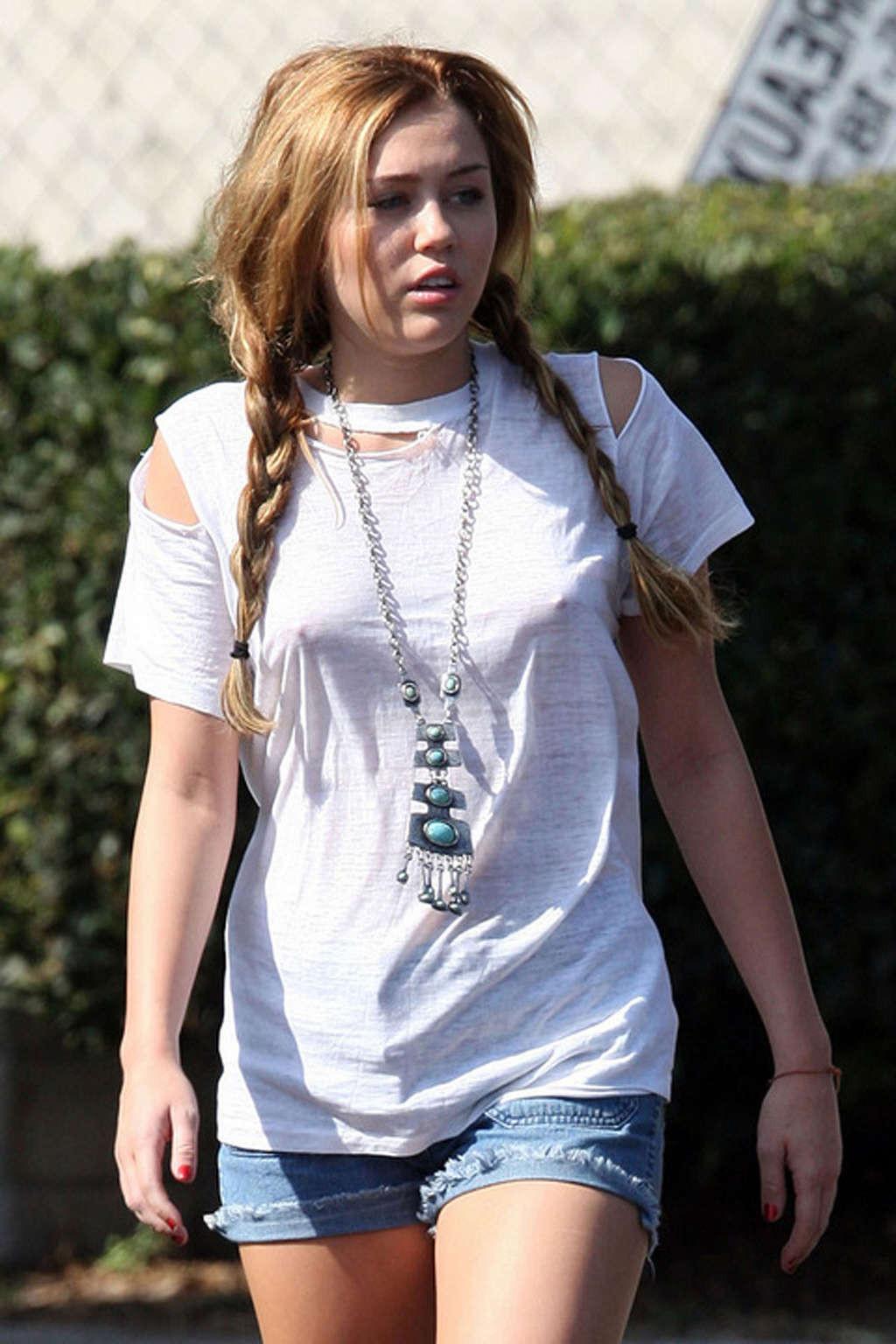 16P Miley Cyrus exposing sexy legs in shorts and hard nipples on street