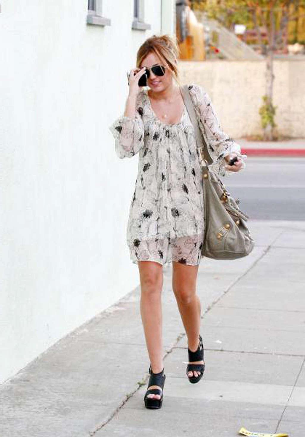10P Miley Cyrus showing her sexy body and hot legs in skirt on street