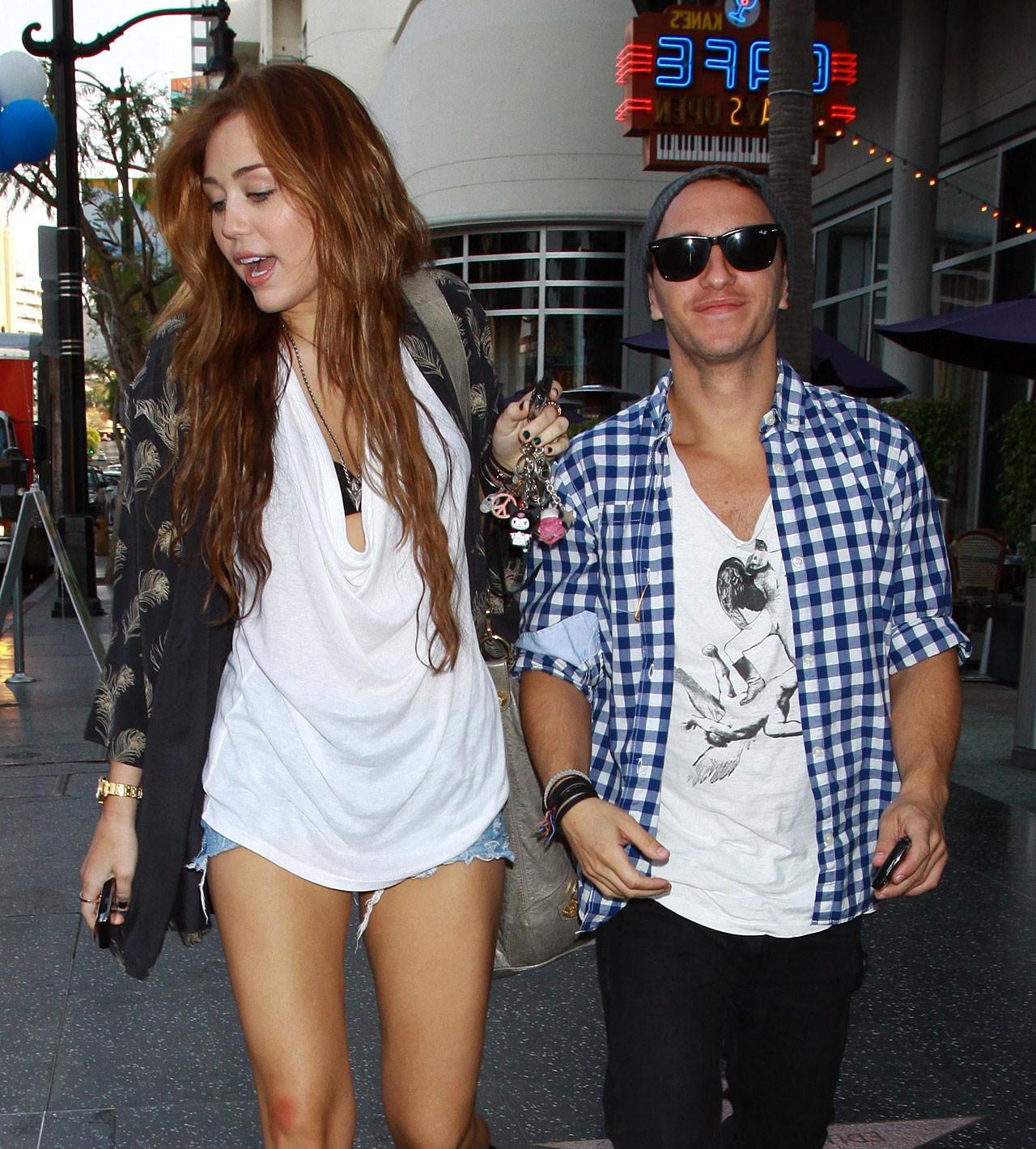 10P Miley Cyrus showing sexy legs on street while she walking with friend