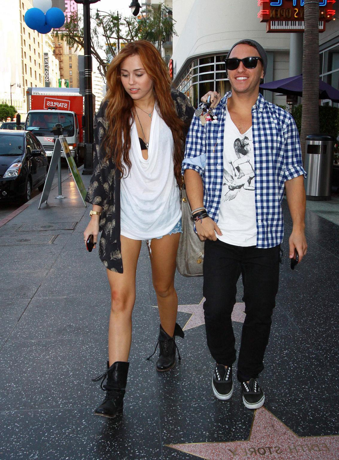 10P Miley Cyrus showing sexy legs on street while she walking with friend