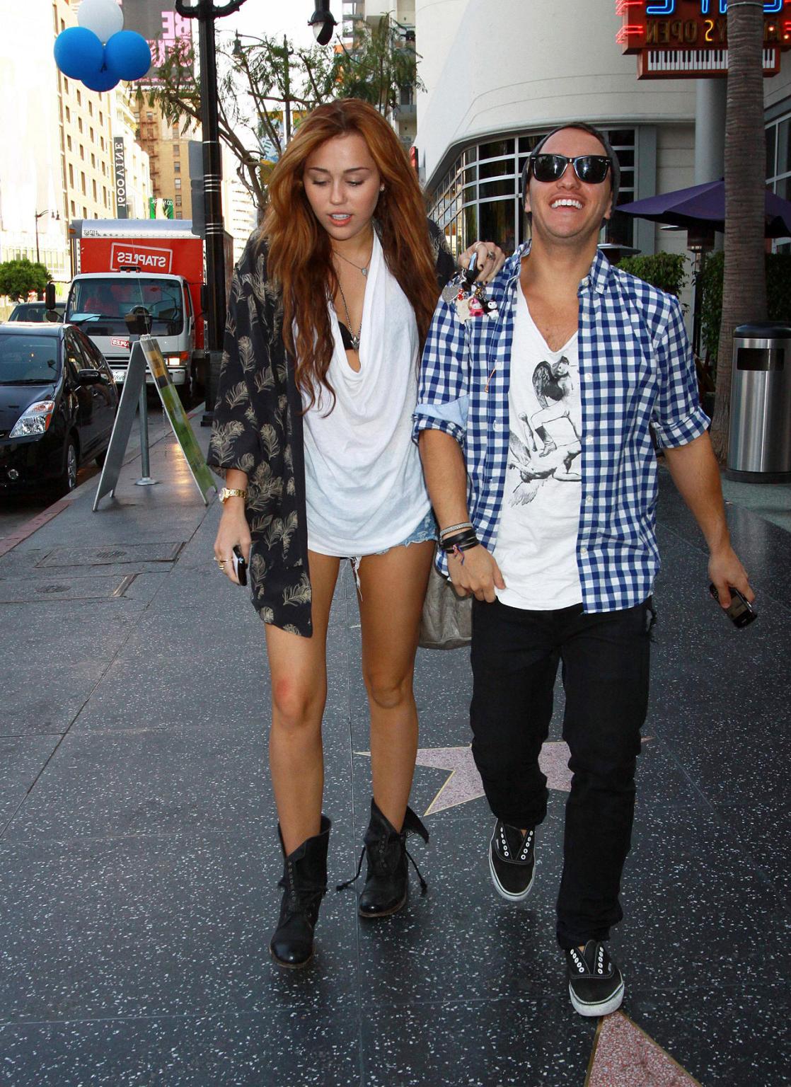10P Miley Cyrus showing sexy legs on street while she walking with friend