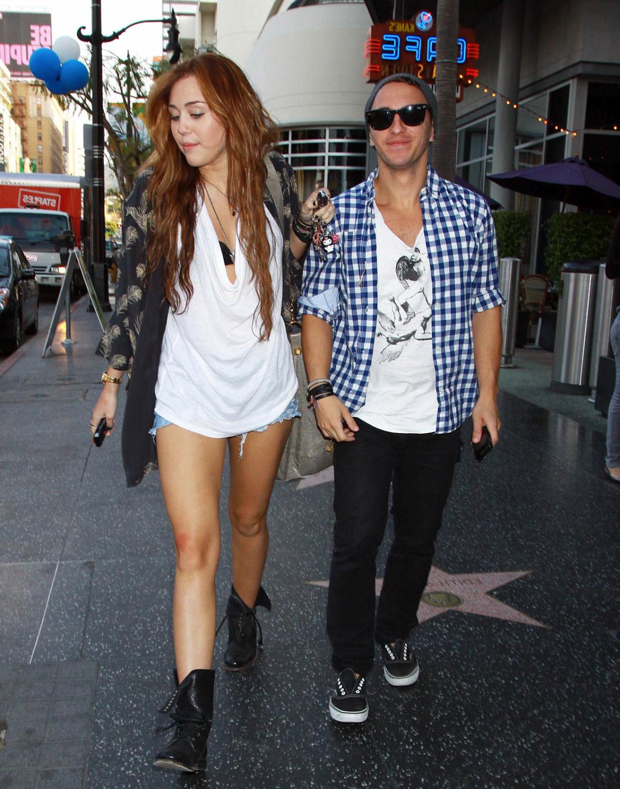 10P Miley Cyrus showing sexy legs on street while she walking with friend