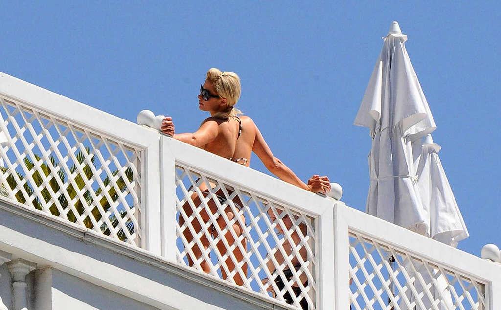 10P Paris Hilton showing her nice ass in thong on balcony and in see thru dress
