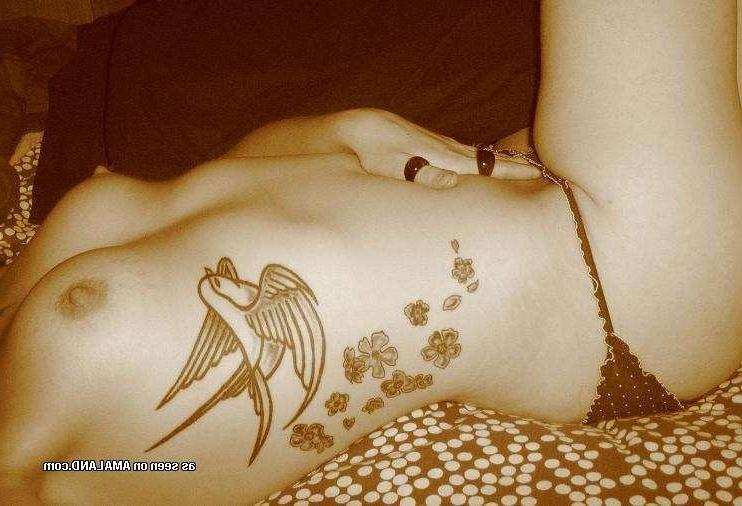 9P Gallery of a sexy inked honey flashing her tits at home