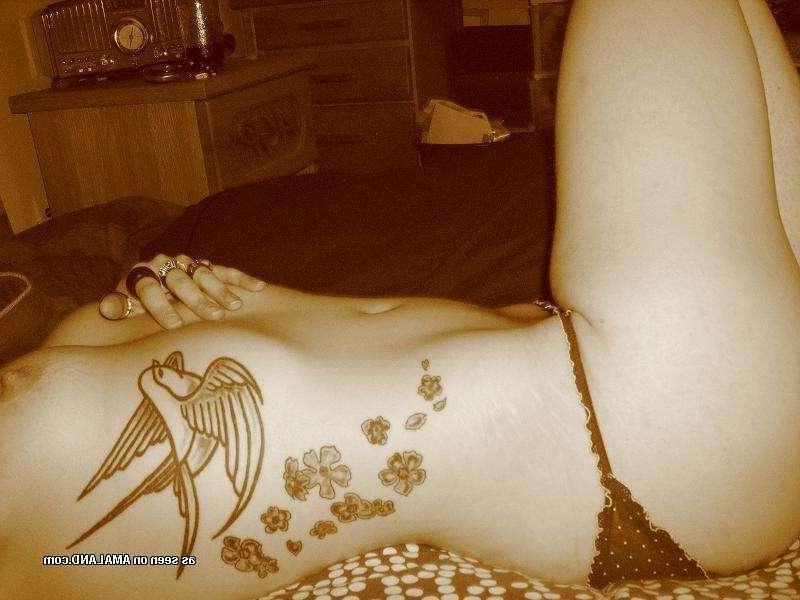 9P Gallery of a sexy inked honey flashing her tits at home