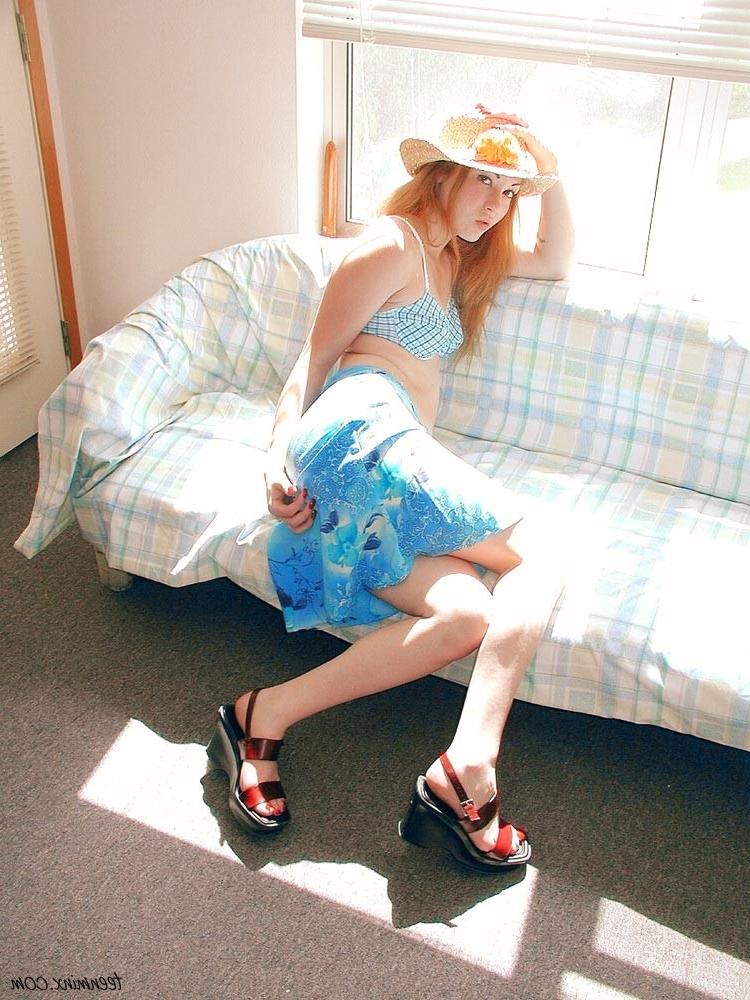 18P Fiery redhead in a skirt spreads and toys her pretty pink pussy