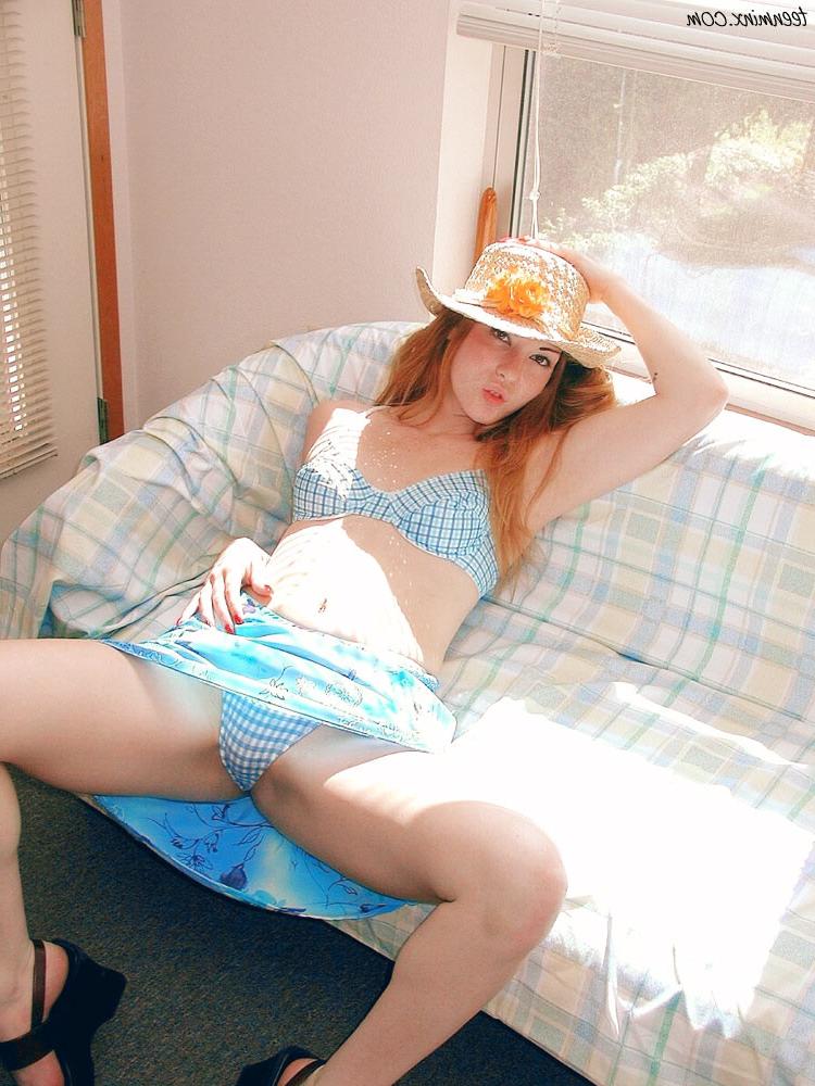 18P Fiery redhead in a skirt spreads and toys her pretty pink pussy