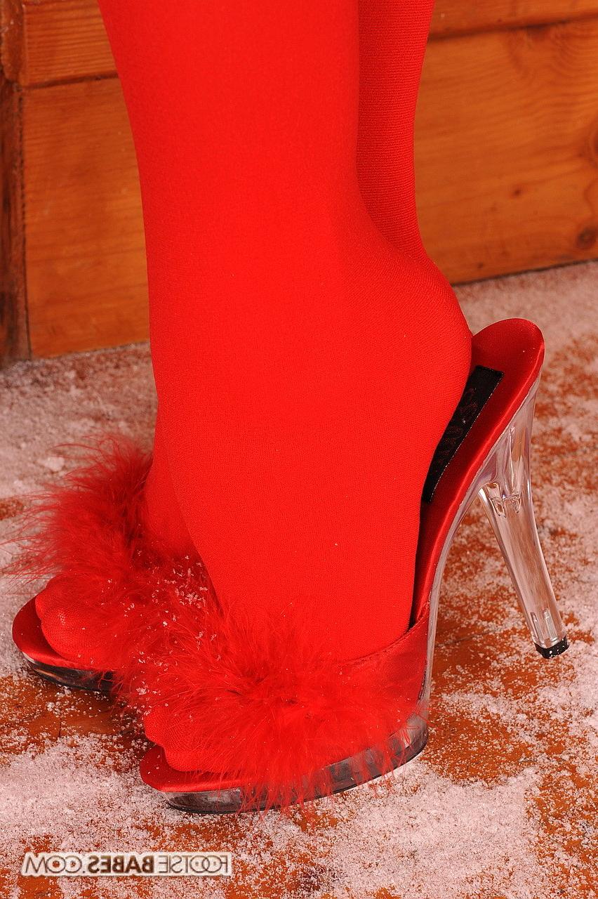 15P Hot babe posing and taking off her red stockings