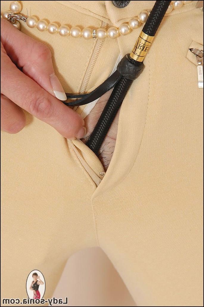 15P Mature kinky lady teasing with a whip in jodphurs