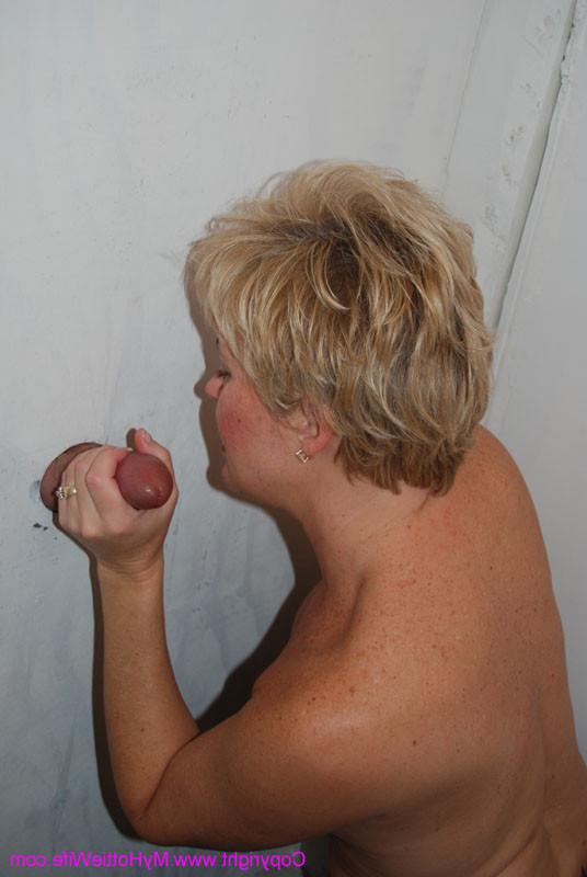 15P A swinger mom sucking a cock through a gloryhole