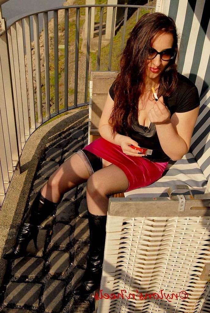 12P Redhead Justine in nylons and boots having a smoke