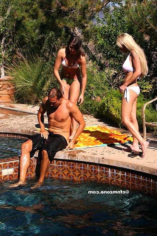 18P Two sunbathing girls massaging a guys groin area near the pool