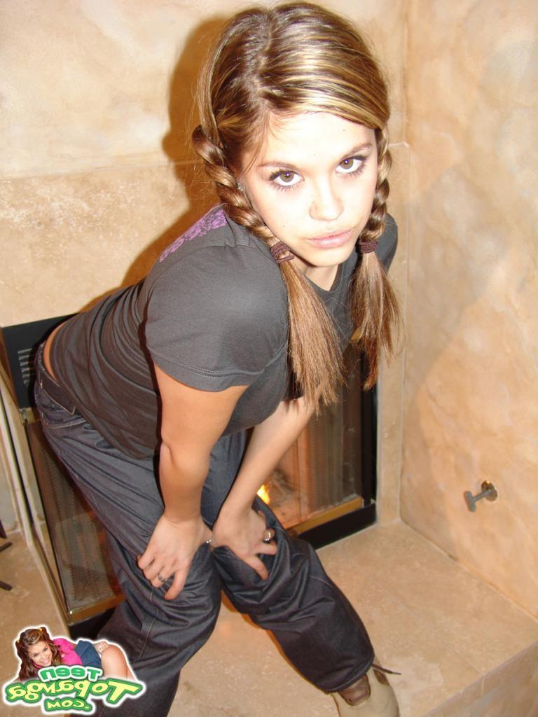 16P A pigtail teenie bends over and fingers her pussy