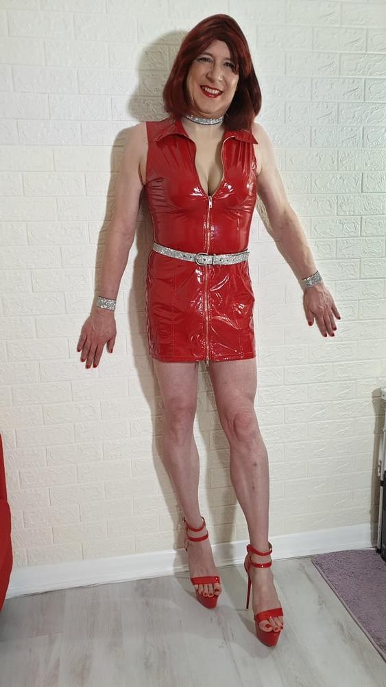 25P TGirl Lucy shows off her big fake tits in red PVC mini dress