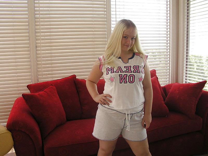 11P Chubby blonde posing on a red sofa