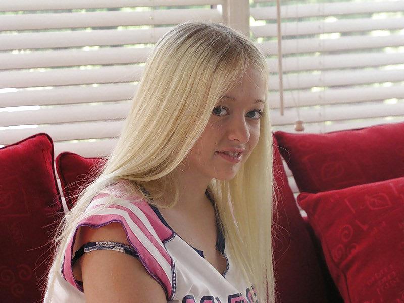 11P Chubby blonde posing on a red sofa