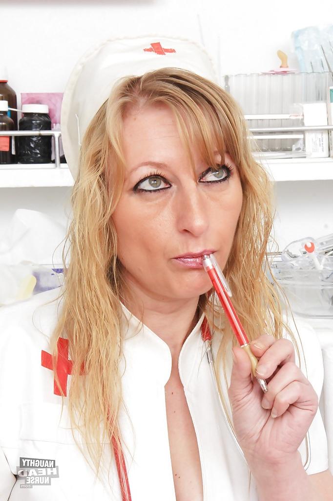 16P Mature blonde Susan Blond is penetrating herself with a red dildo