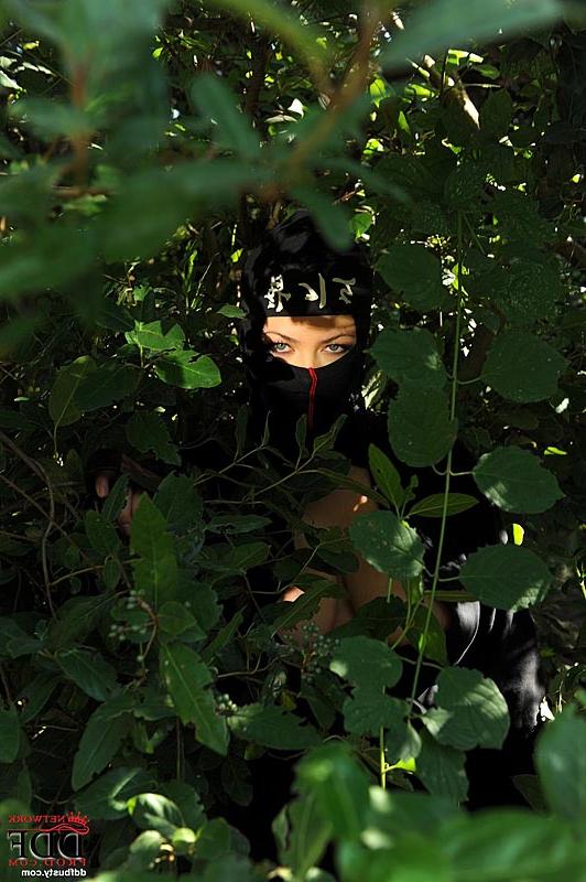 13P Ninja attired babe Shione Cooper freeing large natural tits in the forest