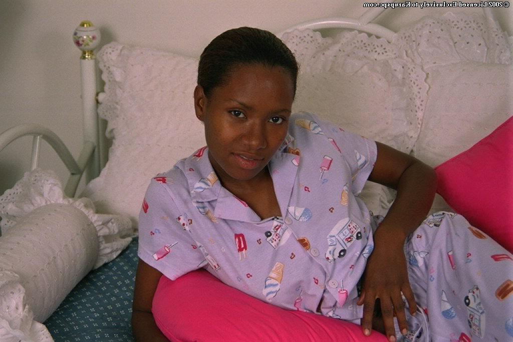 16P Teen ebony Dazy is lying naked and playing with nice big boobs