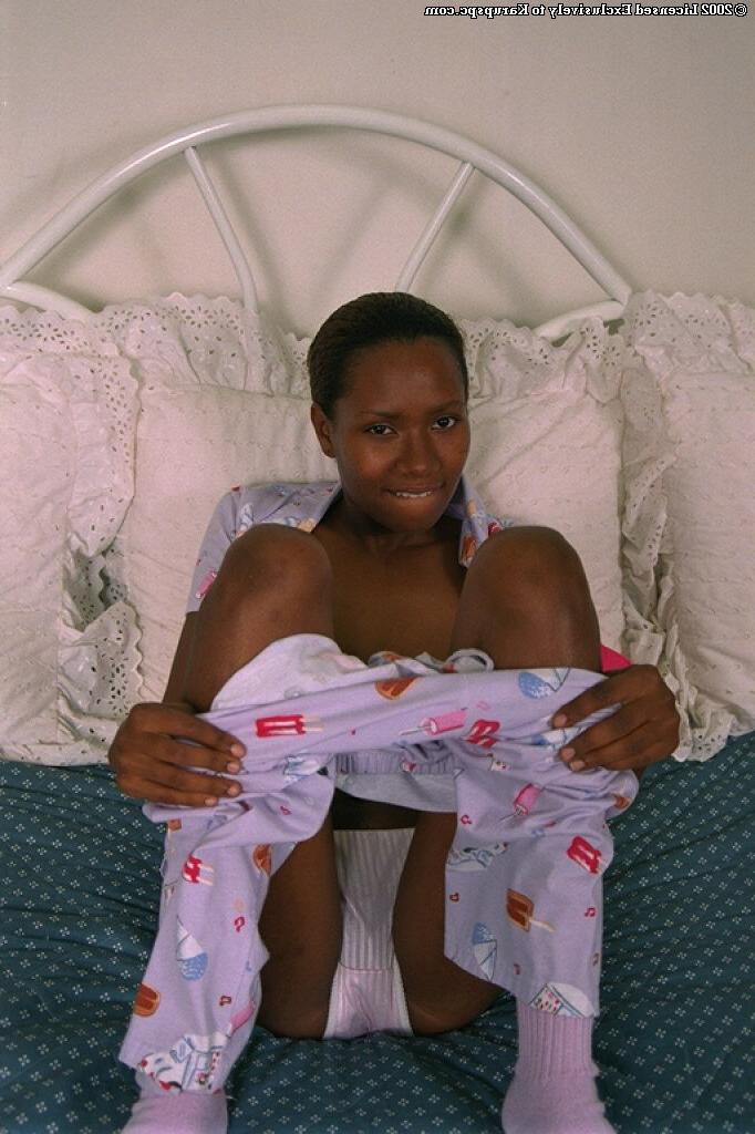 16P Teen ebony Dazy is lying naked and playing with nice big boobs