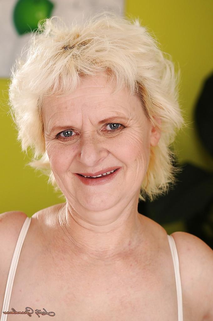16P Salacious granny with big flabby tits stripping off her white lingerie