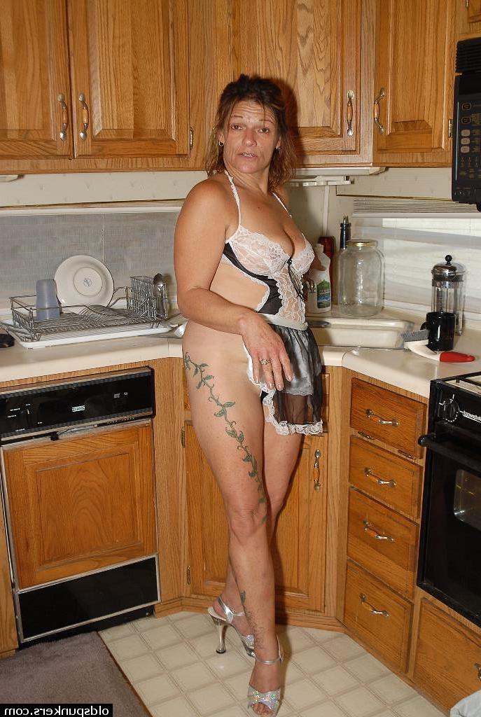16P Experienced blonde lady Ivee showing off thong adorned butt in kitchen