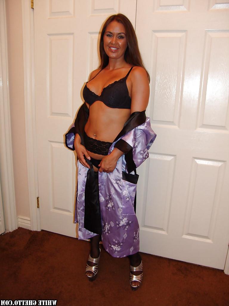 16P Tanned mature Simone Riley poses in her hit black stockings!