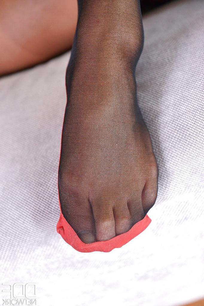 16P Leggy European babe Natalia Forrest freeing barefeet from pantyhose