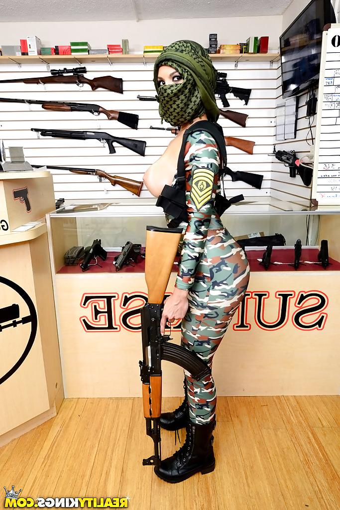 16P Camouflaged chick with rifle in hand lets her big natural breasts loose