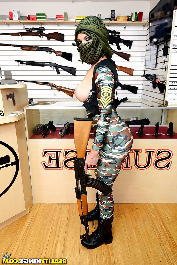 16P Camouflaged chick with rifle in hand lets her big natural breasts loose