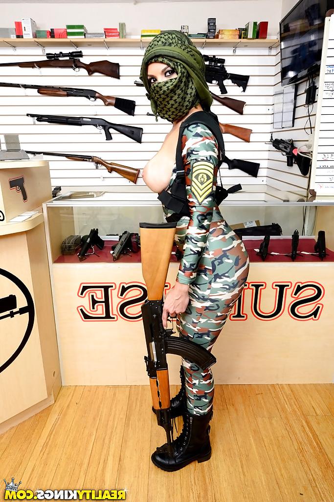 16P Camouflaged chick with rifle in hand lets her big natural breasts loose