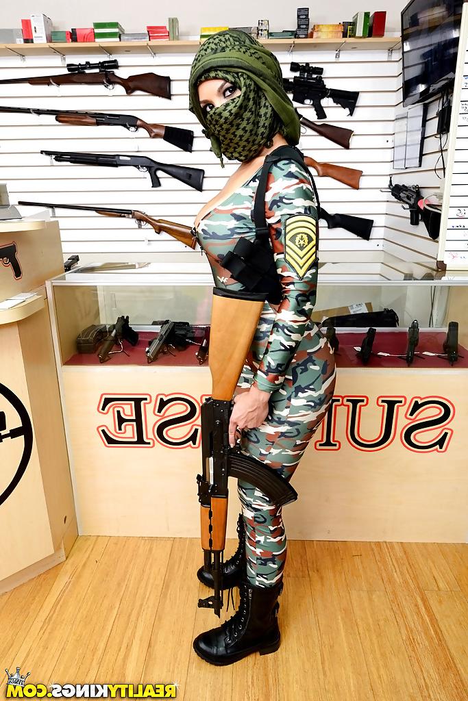 16P Camouflaged chick with rifle in hand lets her big natural breasts loose