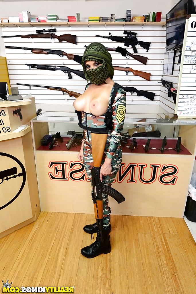 16P Camouflaged chick with rifle in hand lets her big natural breasts loose